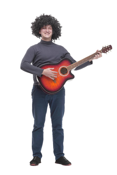 in full growth. curly-haired cheerful man with a guitar. - Zdjęcie, obraz