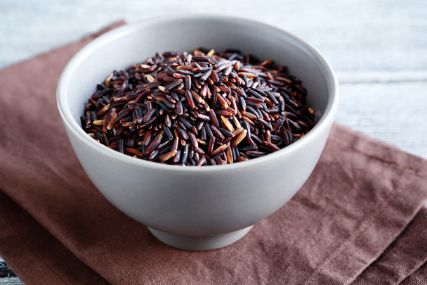Raw black rice in a clay bowl - Foto, immagini