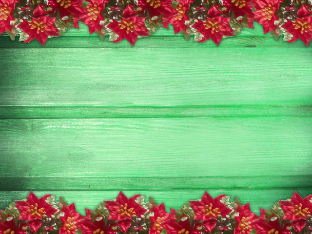 Winter wooden green mint nature background with poinsettia two sides. Texture of painted wood horizontal boards. Christmas, New Year card with copy space. Card for congratulation, invitation, party, message for Christmas, New Year. Can be used for we - Фото, зображення