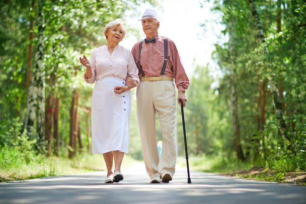 Ηλικιωμένο ζευγάρι περπατά στο πάρκο - Φωτογραφία, εικόνα