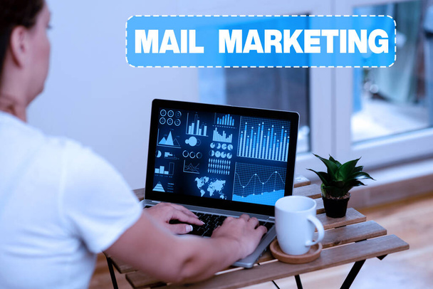 Text caption presenting Mail Marketing. Business idea sending a commercial message to build a relationship with a buyer Woman Doing Work On Laptop Next To Plant And Mug Working From Home. - Foto, Bild