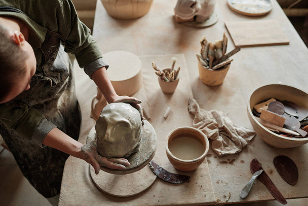 Женщина создаёт человеческое лицо из глины - Фото, изображение