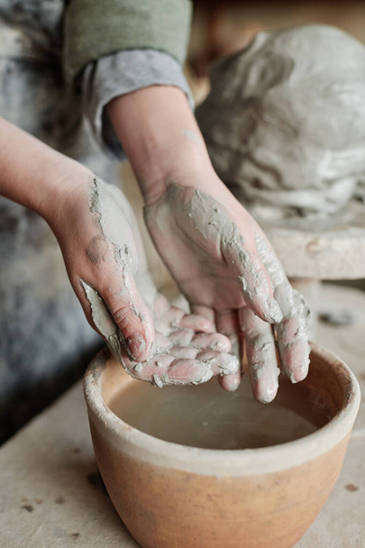 Sculptor working with clay in studio - Photo, Image