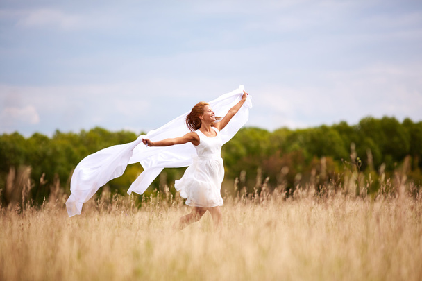 Happy woman with white fabric - Foto, Bild