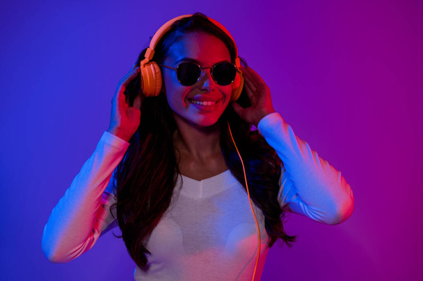Photo of cool millennial clubber brunetka lady słuchać muzyki noszenie białego górnej okulary izolowane nad gradientowym tle koloru - Zdjęcie, obraz