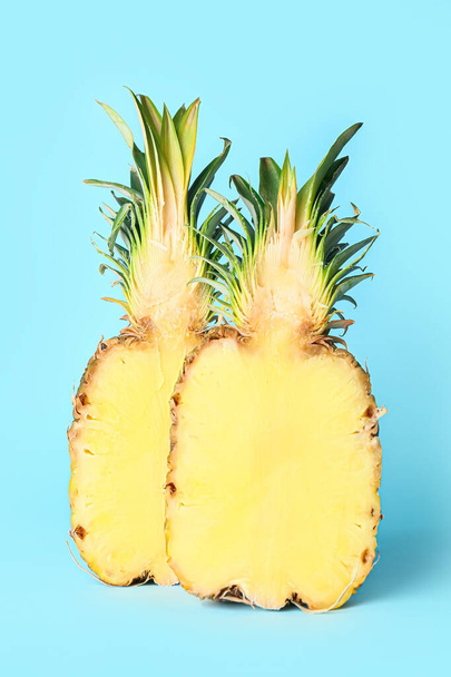 Halves of fresh juicy pineapple on color background - Fotó, kép