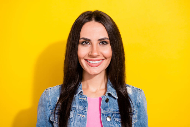 Portrait of attractive content cheerful brunet girl wearing cozy jeans blazer isolated over bright yellow color background - Zdjęcie, obraz