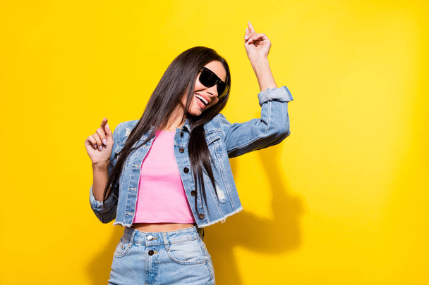 Portrait of attractive cheerful girl wear black specs dancing having fun weekend isolated over bright yellow color background - Фото, зображення