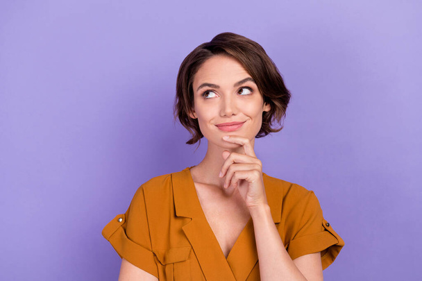 Photo of young woman happy positive smile hand touch chin think minded isolated over violet color background - Foto, afbeelding