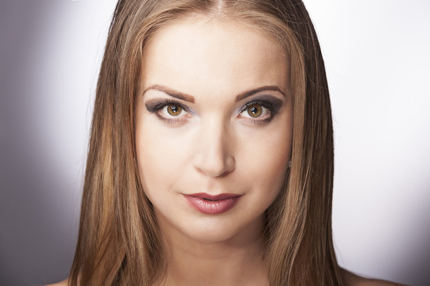 Close-up portrait of beautiful young woman on dark blue background - Fotografie, Obrázek