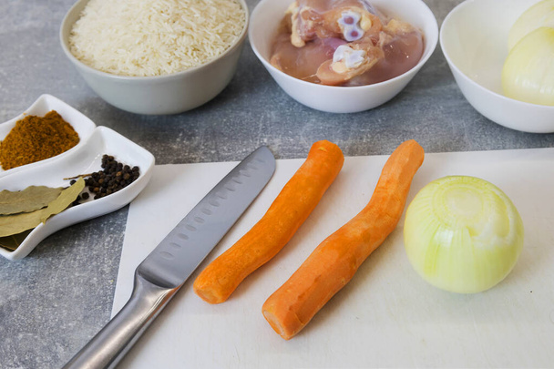 Ingredients for pilaf. Carrots, onion bulbs, rice, sliced meat, salt, barberry, saffron, cumin powder, oil. Step-by-step cooking process. - Photo, Image