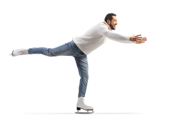 Man in jeans and white knitwear practicing ice skating isolated on white background - Photo, Image