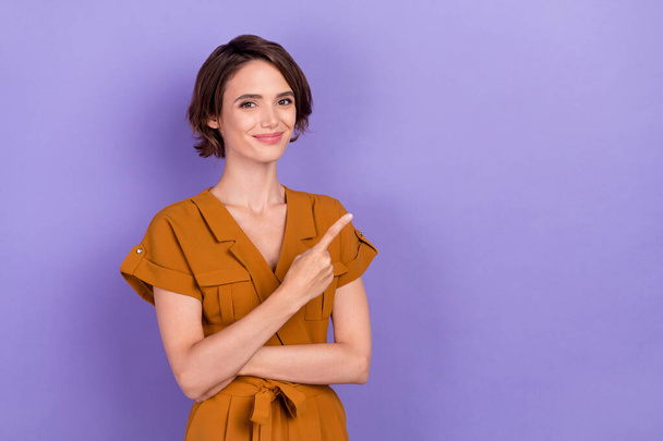 Photo of young attractive woman happy positive smile point finger empty space ad choose isolated over violet color background - Фото, изображение