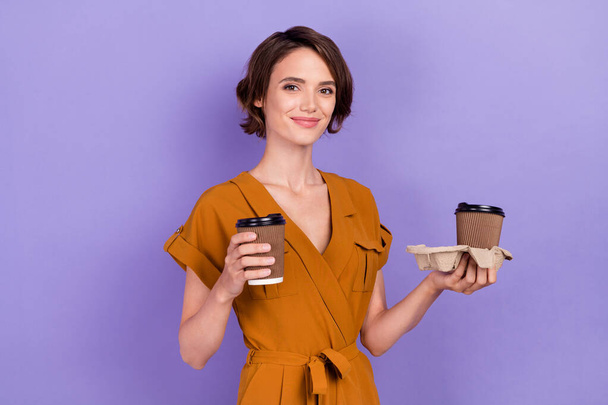 Photo of young attractive woman happy positive smile drink coffee break morning isolated over purple color background - Foto, imagen