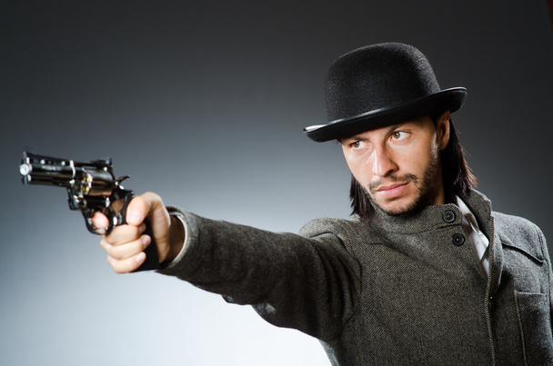 Man with gun and vintage hat - Photo, Image