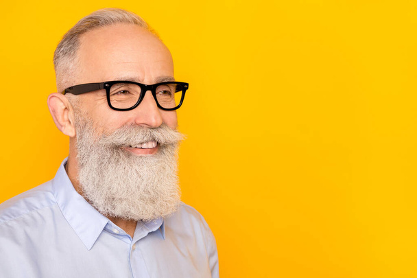 Photo of dreamy happy old charming man look empty space wear glasses isolated on yellow color background - Φωτογραφία, εικόνα