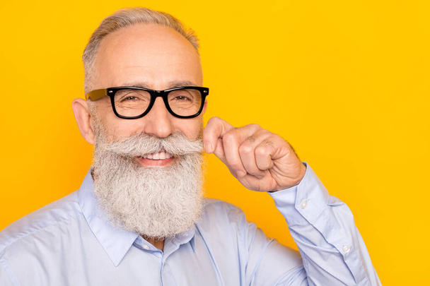 Photo of charming imposing old man wear glasses fix mustache good mood isolated on yellow color background - Фото, изображение