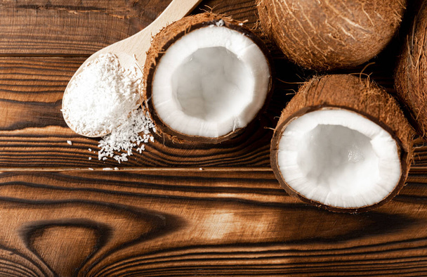 coconut flakes on a wooden spoon, coconuts on a wooden background. Close-up. copy space. - Fotó, kép