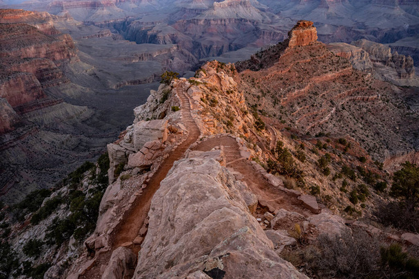 Rock Overlooking the South Kaibab Trail as it Winds down into the Grand Canyon in morning light - Zdjęcie, obraz