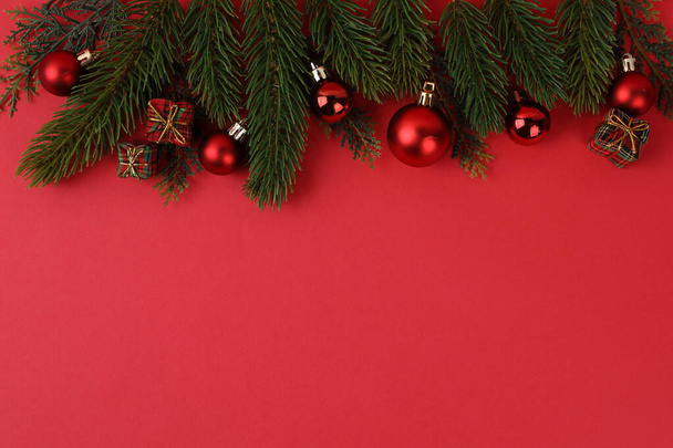 Christmas gift box and ornaments in red background - Fotó, kép