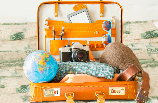 Suitcase full of items for travel. Illusion, hope, joy and new destinations. - Foto, Imagem