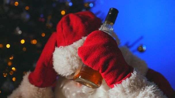 Santa with bottle of whiskey after the new year. - Фото, зображення