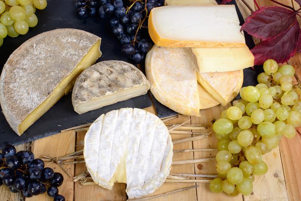 French cheeses with white and black grapes - Photo, Image