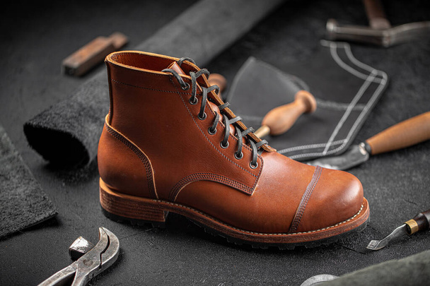 Handcrafted brown leather shoe with cobbler tools - Foto, immagini
