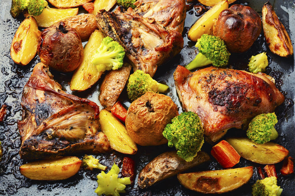 Fried chicken meat in vegetables and fruits. Roasted meat. Close up, food background - Photo, Image