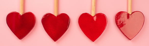 επίπεδη lay σε σχήμα καρδιάς γλειφιτζούρια που απομονώνονται σε ροζ, banner - Φωτογραφία, εικόνα