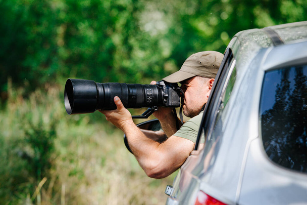 Wildlife photographer outdoor. Professional photographer in nature. - Photo, Image