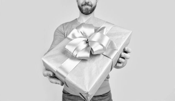 present or gift box closeup in hands ofcropped man, selective focus, discount - Photo, image