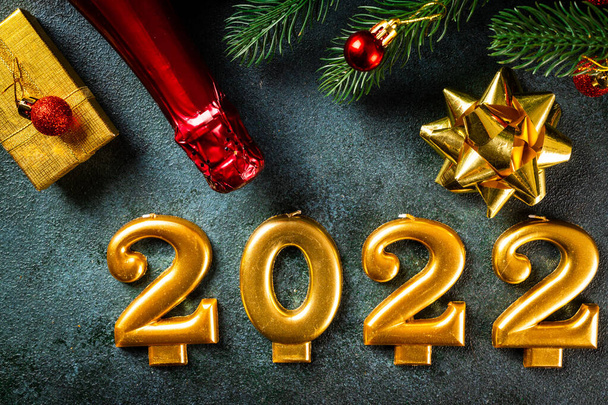 2022 numbers with champagne bottle and decor. Happy new year and festive concept. Top horizontal view copyspace. New Year Flatly. Christmas flatlay. New year 2022. New year concept. - Photo, Image