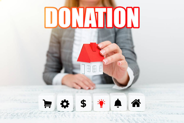 Text caption presenting Donation. Internet Concept something that is given to a charity, especially a sum of money A Young Lady Orbusinesswoman Holding Orpresenting Home In Business Outfit - Photo, Image