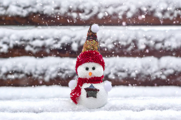 Merry christmas and happy new year greeting card with copy space Happy little snowman in red cap and scarf standing in winter snow background Xmas fairytale Hello January, February concept - Fotó, kép