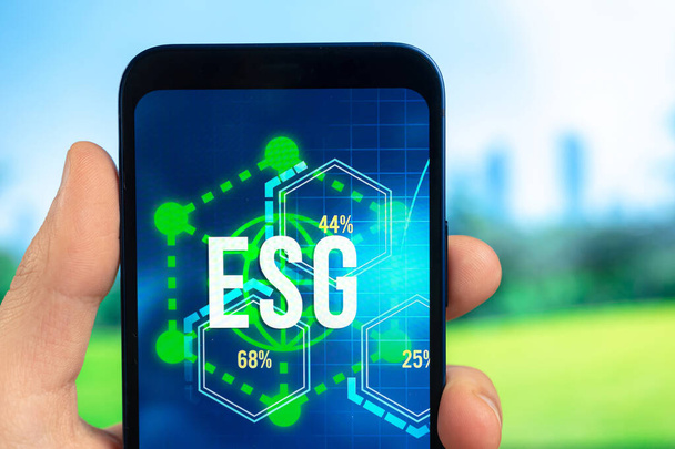 ESG concept. Environmental, social and governance in sustainable and ethical business. Smartphone in hand. Ecology care  - Fotó, kép