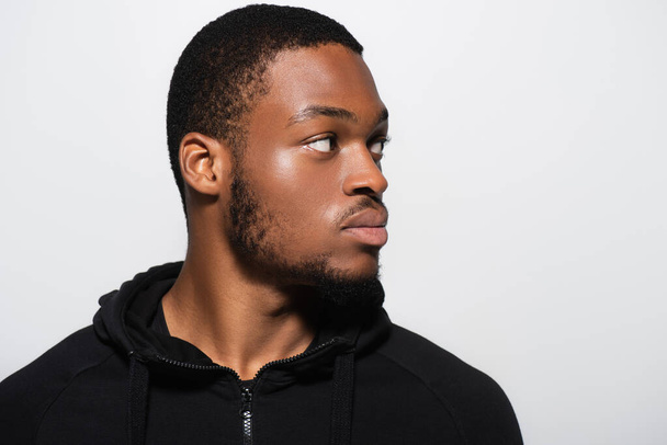 young african american man in hoodie looking away isolated on grey - Фото, зображення