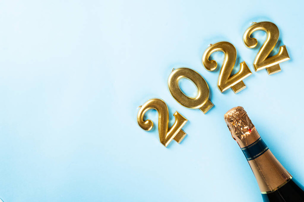 2022 number with champagne bottle and decor. Happy new year and festive concept. Top horizontal view, copyspace. New Year Flatly. Christmas flatlay. New year 2022. New year concept. - Photo, Image
