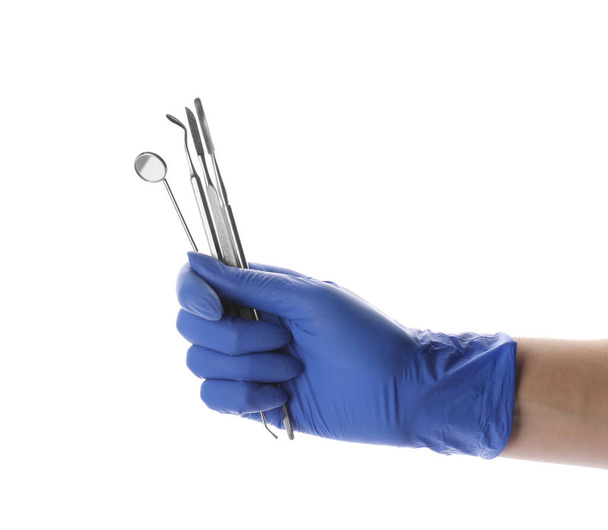 Dentist holding set of tools on white background, closeup - Foto, immagini