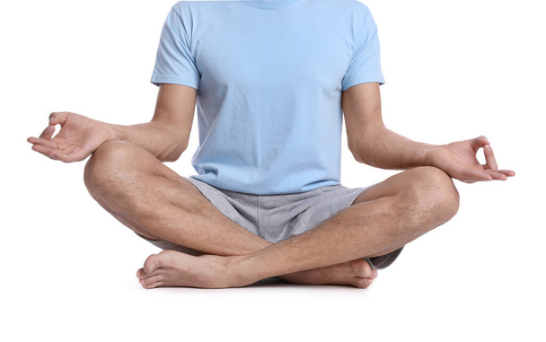 Man meditating on white background, closeup. Harmony and zen - 写真・画像