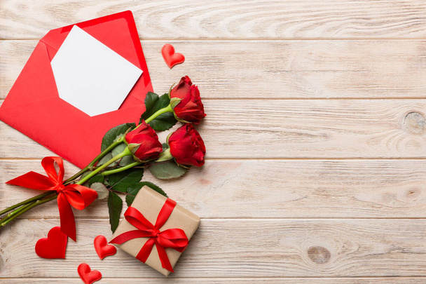 Valentine day composition with Envelope, rose flower and Red heart on table. Top view, flat lay. Holiday concept. - Foto, immagini