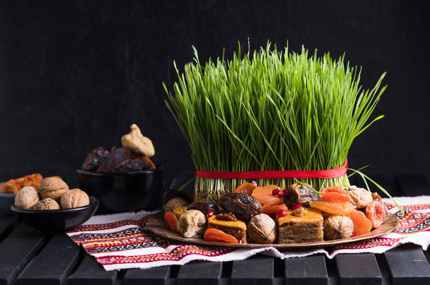 Novruz setting table decoration,  wheat grass, Azerbaijan national pastry pakhlava, new year sring celebration, nature awakening - Photo, Image