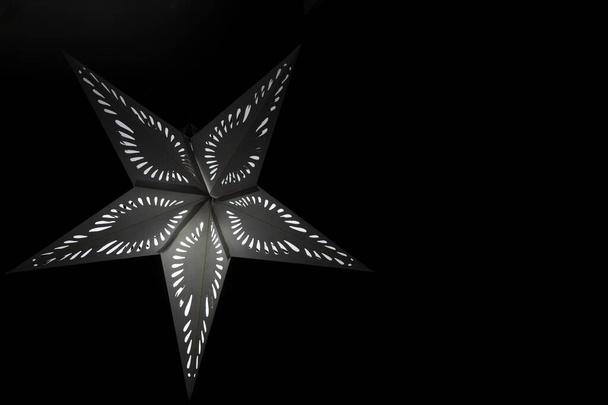 White Christmas star on a black background - Zdjęcie, obraz