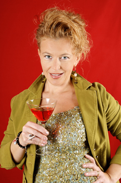 Beautiful blond woman with red drink - Фото, изображение
