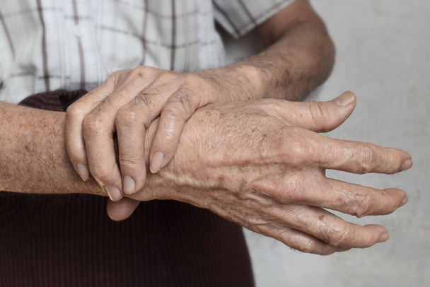 Hands of Asian, Myanmar elder man. Concept of joint pain, arthritis, tendonitis or hand problems. - Fotó, kép