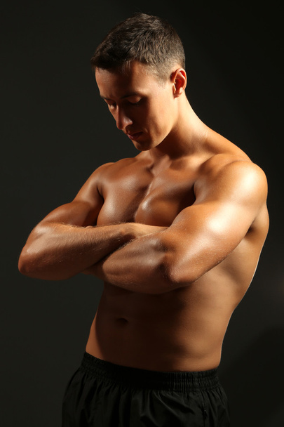 Handsome muscle young man on dark background - Photo, Image