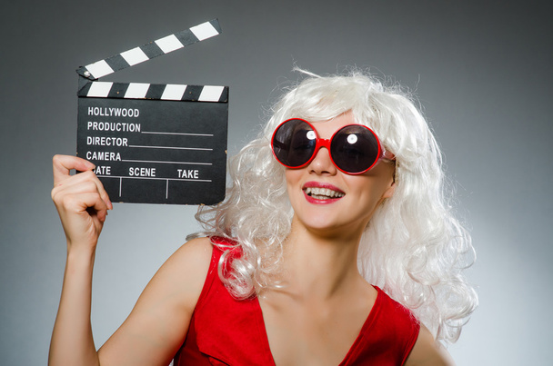 Blond woman with movie board - 写真・画像