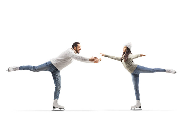 Casual young man and woman practicing ice skating isolated on white background - Φωτογραφία, εικόνα