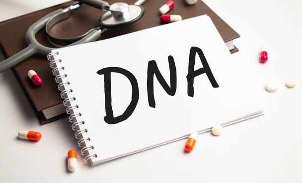 dna abbreviation on the notepad with stethoscope - Foto, imagen