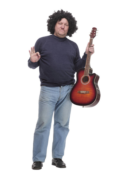 in full growth. curly-haired mature man with a guitar. - Fotó, kép
